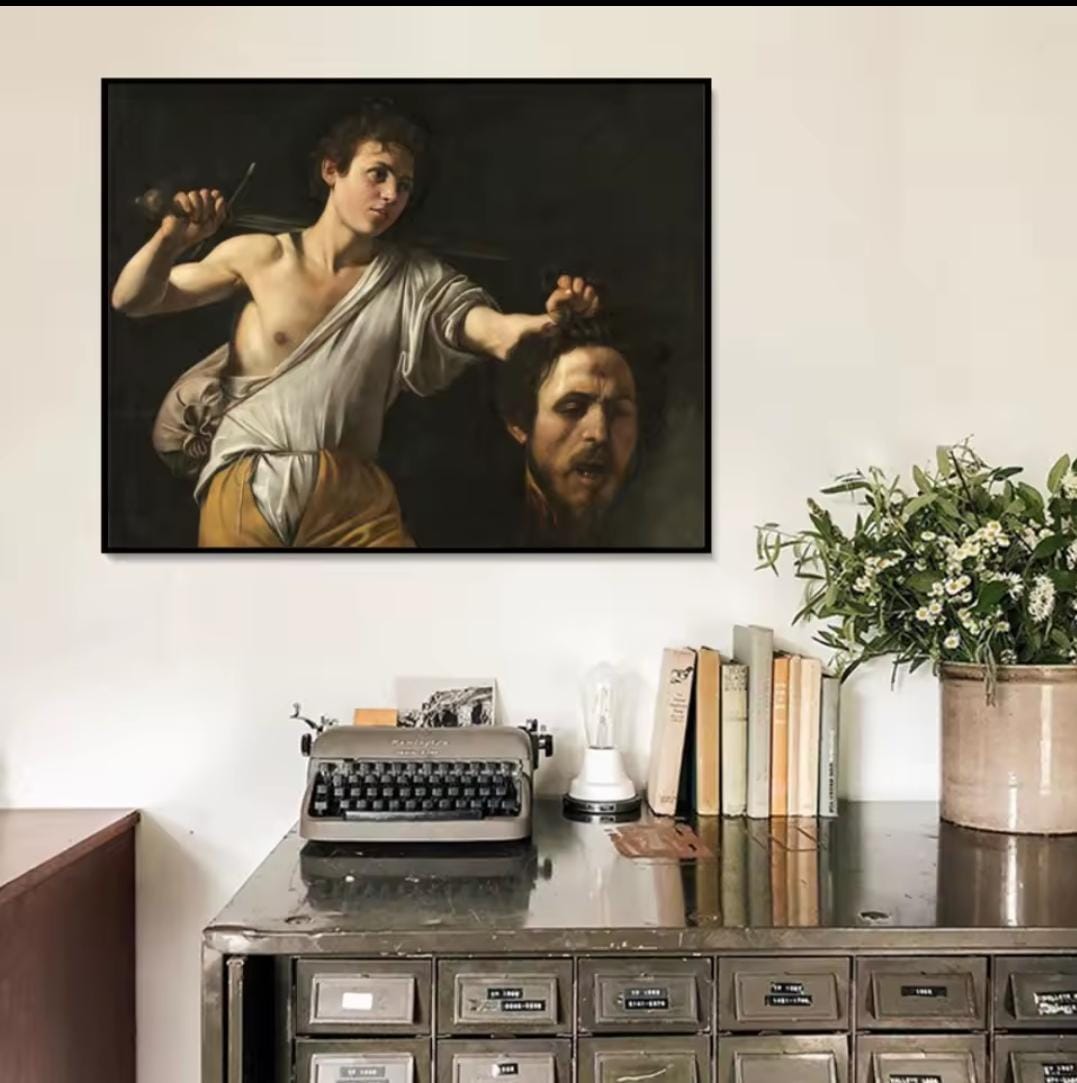 David con la testa di Golia Caravaggio: quadro arte Barocca che ritrae David che tiene la testa recisa di Golia. Stampa su tela capolavoro classico caratterizzata dal potente chiaroscuro.