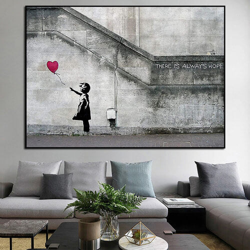 Quadro Bambina con Palloncino di Banksy, un'opera d'arte urbana che rappresenta un momento di innocenza e speranza, ideale per spazi creativi e riflessivi.