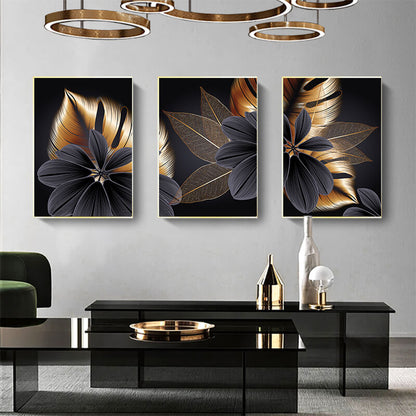 Set di tre quadri “Essenza Floreale”: fiori stilizzati su sfondo nero con petali grigi e sfumature oro.
