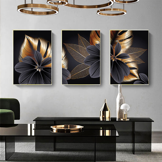 Set di tre quadri “Essenza Floreale”: fiori stilizzati su sfondo nero con petali grigi e sfumature oro.